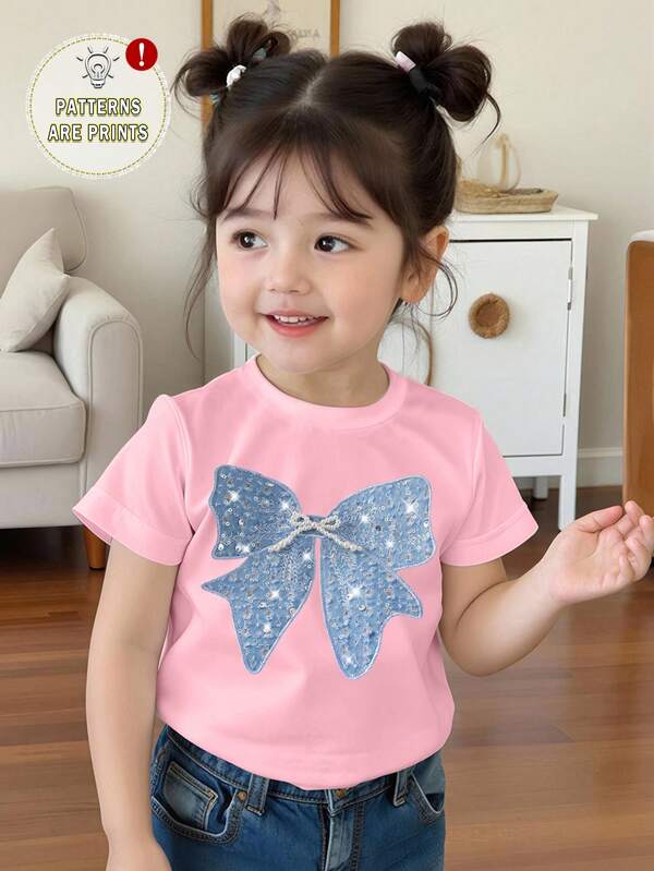Camiseta básica rosa de manga corta con estampado de lazo azul brillante, decoración minimalista y personalidad creativa para niñas bebés en primavera y verano, uso diario cómodo