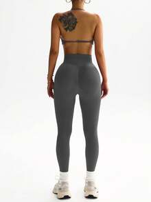 Dewbera Bộ đồ thể thao nữ gồm áo croptop hở lưng và quần legging. - Màu xám đen - Xem 6