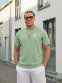Manfinity EZcore Suitable For Both Business Commute And Casual Wear, Light Green Short Sleeve T-Shirt With "Still Willing To Follow Freedom" Printed Pattern, Paired With White Athletic Shorts, A Fresh, Relaxed, Casual Outfit. Fashionable And Exquisite, Also An Excellent Gift For A Boyfriend. Men's Shorts Set, Plus Size Men's 2 Pieces Set, Travel Suit. - Black - View 1