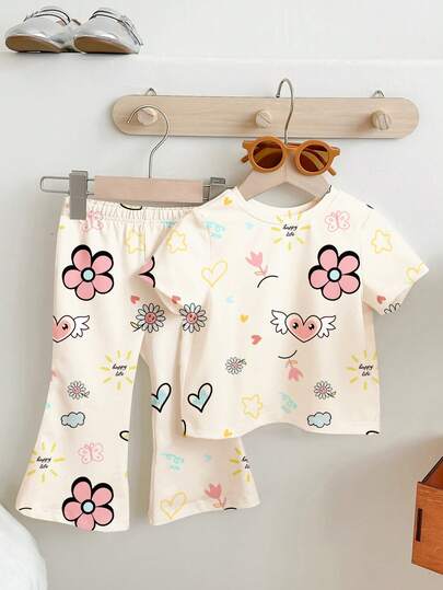 SHEIN Cream White, Cute Hand-Painted Floral & Heart Graffiti Print, Young Girl Casual Minimalist Short Sleeve Round Neck T-Shirt And Flare Pants Set, Suitable For Daily Wear, Street Style, Outing, Home, Vacation, Homecoming, Back To School, Spring & Summer