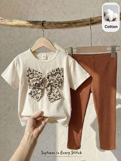 Cozy Pixies Set de 2 piezas con top de manga corta con cuello redondo y decoración de lazo con estampado de leopardo, y pantalones de cintura elástica para niña joven