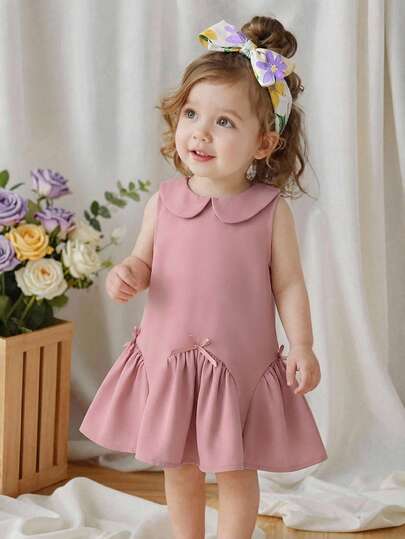 Souflis Souflis 女婴夏季连衣裙，主色调为柔和的粉色，搭配彼得潘领和无袖设计，荷叶边下摆，腰间蝴蝶结点缀，尽显甜美公主风，时尚可爱，是女婴的理想之选。