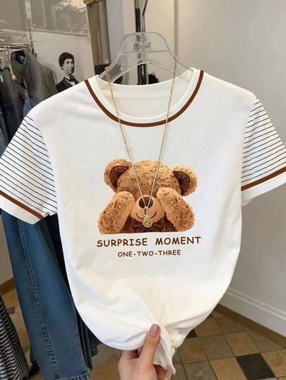 Resyla Cute Bear Print Striped Sleeve Contrast Ringer Tee Y2K Aesthetic Teddy Bear Graphic Contrast Trim T-Shirt Preppy Style "Surprise Moment" Bear Print Casual Tee Contrast Neck Striped Sleeve Bear Graphic Top Retro Teddy Bear Print Striped Sleeve Summer Tee