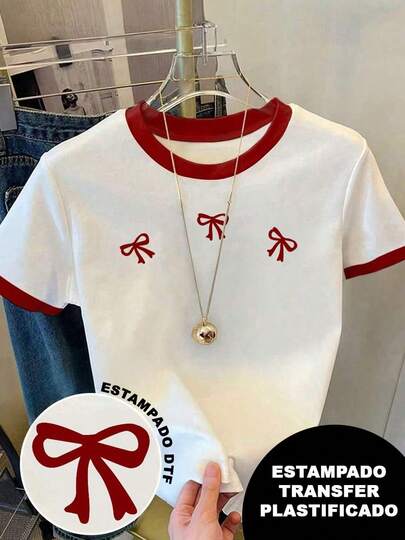 Playera patchwork, bicolor con cuellos y mangas color rojo, con diseño de moños rojos, estampado transfer plastificado. Diseño colorido, llamativo y moderno, cuello redondo, manga corta, ideal para uso diario. Playera holgada, a la moda.