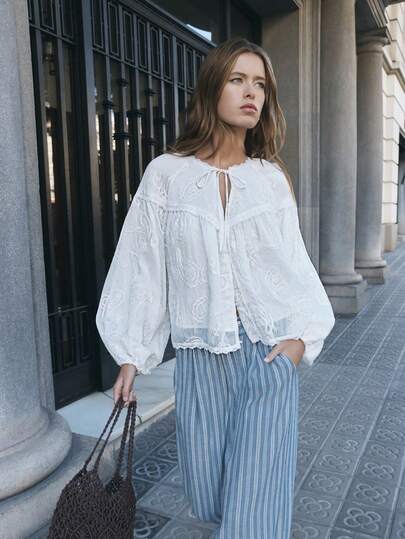 Nöista White Embroidered Blouse Long Sleeves Features Delicate Floral Embroidery, And Voluminous Sleeves. With A Tie-Front Neckline. Boho, Summer, Spring, Easter.