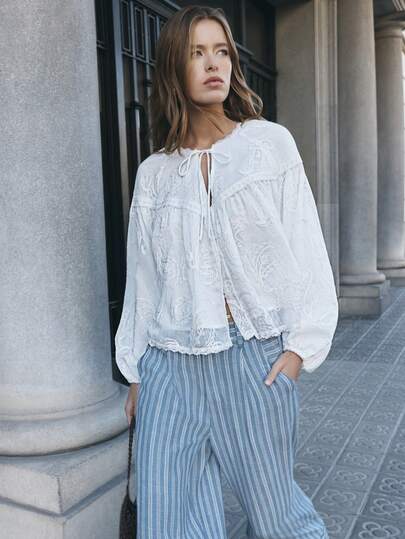 Nöista White Embroidered Blouse Long Sleeves Features Delicate Floral Embroidery, And Voluminous Sleeves. With A Tie-Front Neckline. Boho, Summer, Spring, Easter.