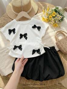 Cozy Pixies Conjunto de 2 piezas de top de manga corta con cuello redondo y decoración de lazo, y shorts de cintura elástica en bloques de color para niña bebé, conjunto casual para vacaciones - Blanco y Negro - Ver 3