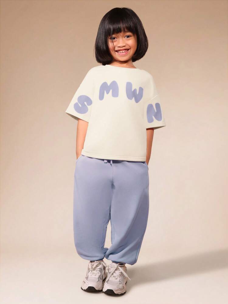 Ensemble deux pièces pour jeunes filles avec t-shirt à col ras du cou oversize à manches courtes avec imprimé graphique et jogging détente avec imprimé slogan