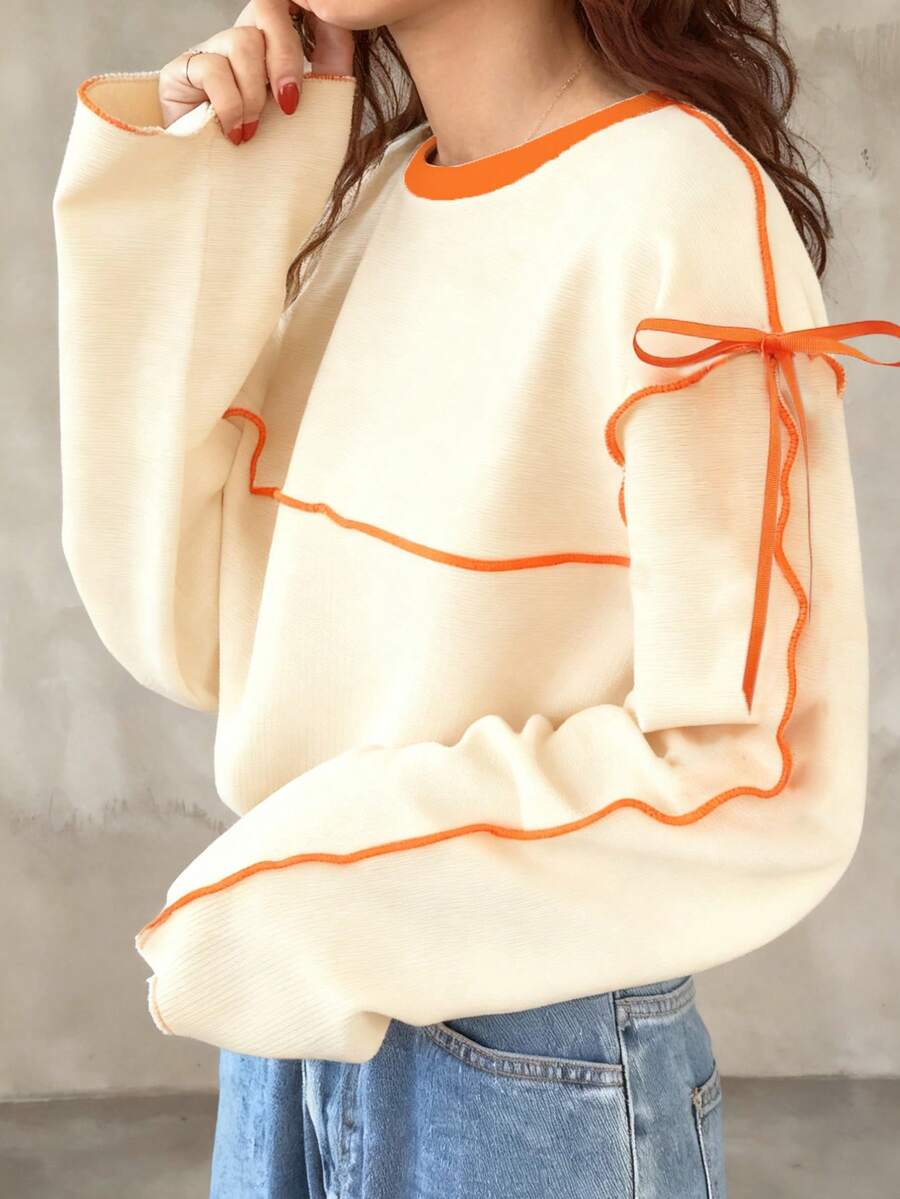 FRIFUL Áo thun dài tay nữ dáng rộng cổ tròn phối màu tương phản có nơ - Màu be - Xem 1