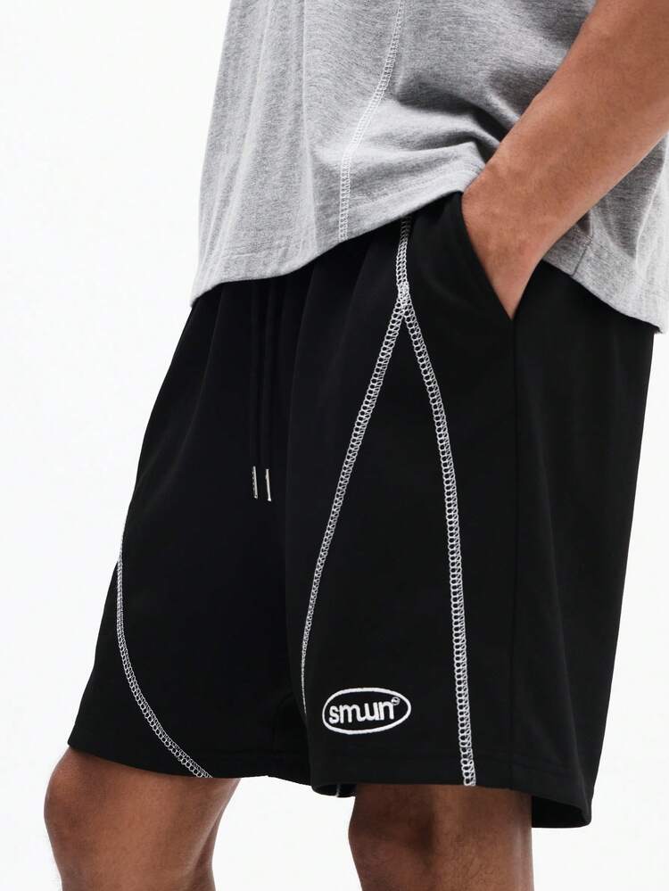 Pantaloncini neri con coulisse e cuciture a contrasto
