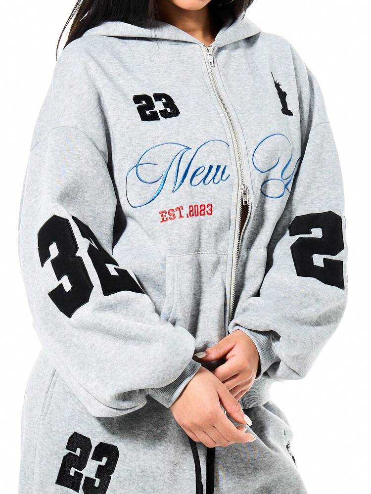 SUMWON Sudadera con capucha de ajuste holgado para mujer con cremallera completa, con gráficos de la estatua de la Libertad de Nueva York y detalles de texto, ropa casual de calle