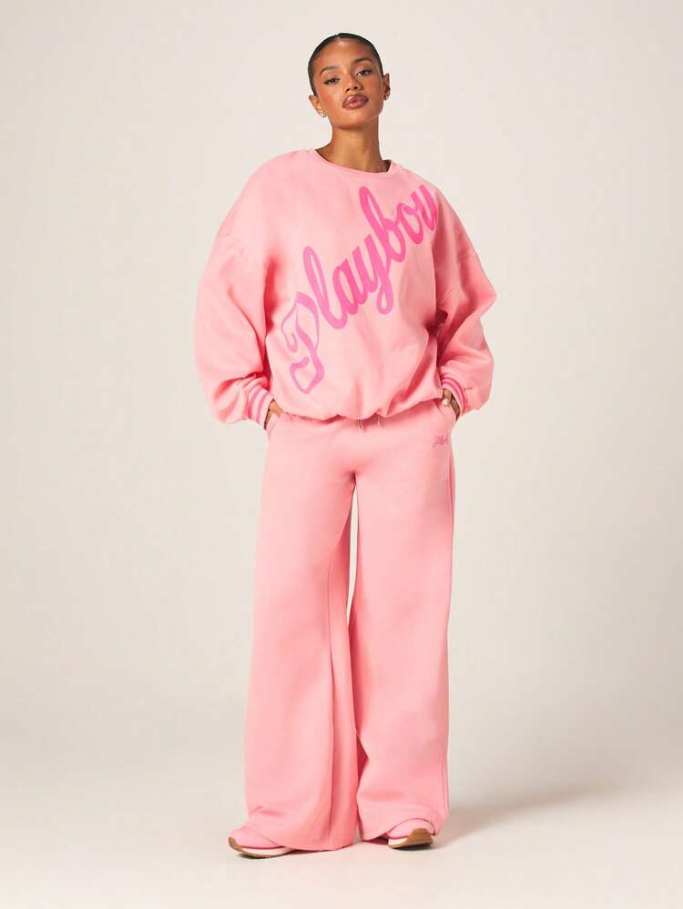 Missguided x Playboy Pantalon de jogging ample à taille haute en velours rose avec logo script et taille élastique pour le loungewear
