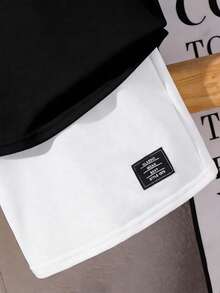 SHEIN Conjunto informal de 2 piezas para niño preadolescente con camiseta de manga corta con gráfico de letra grande y pantalones cortos de unicolor, estilo callejero - Blanco y Negro - Ver 6