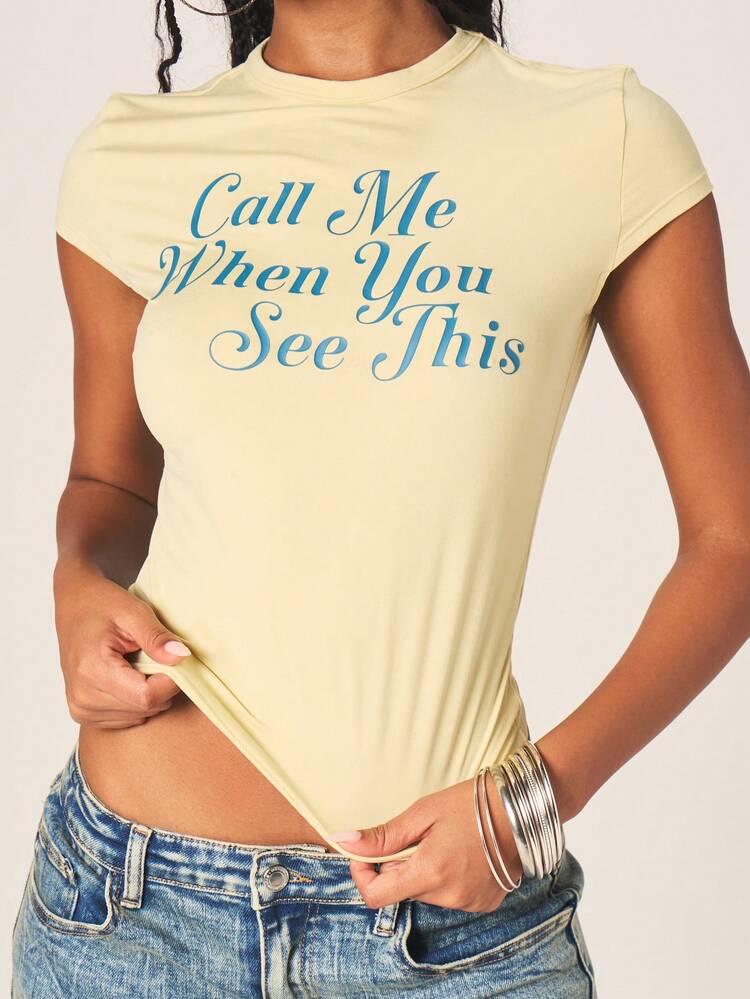 MISSGUIDED Women's Call Me When You See This Baby Tee Short Sleeve Crew Neck Fitted Yellow T-Shirt With Text Print Casual Top