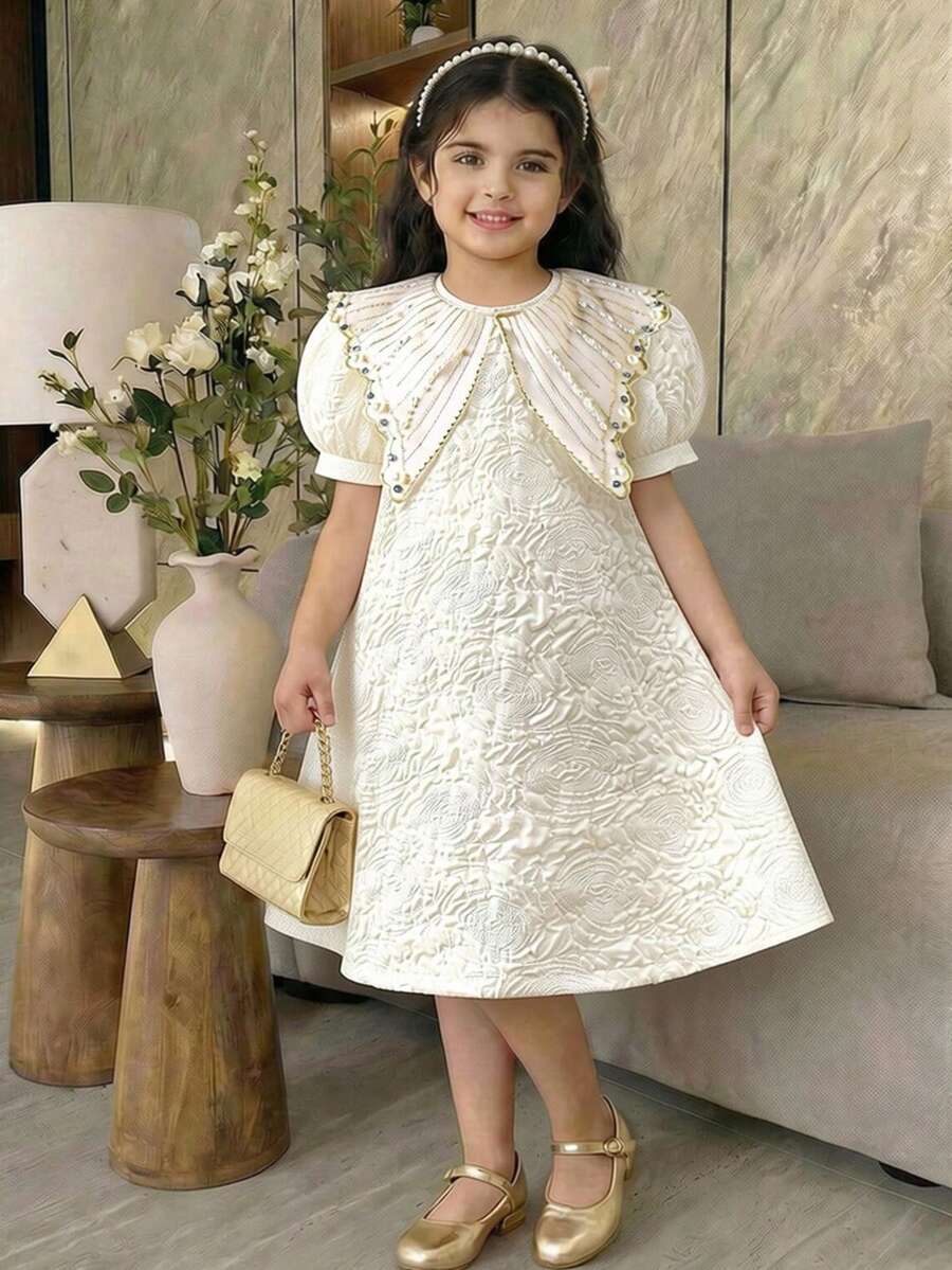 Đầm bé gái mùa xuân/hè/thu thanh lịch, tối giản, chất liệu vải dệt nổi, màu mơ, cổ áo thêu ngọc trai và đá pha lê, tay phồng, thích hợp cho mùa xuân/hè, kiểu dáng tối giản, thanh lịch, duyên dáng, phù hợp cho đi học, dã ngoại, kỳ nghỉ, tiệc tùng, lễ hội. - Màu be - Xem 1