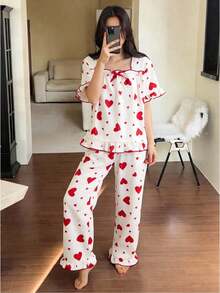 女童两件套睡衣：短袖上衣，饰有蝴蝶结和爱心印花，荷叶边下摆；宽松长裤，荷叶边下摆。 - 杏色 - 查看 3