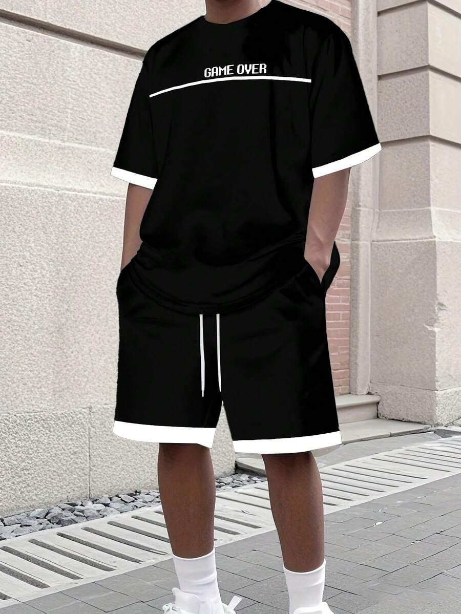 Manfinity EMRG Conjunto de camiseta y pantalones cortos de estilo callejero para hombres "GAME OVER" en contraste blanco y negro - Multicolor - Ver 1
