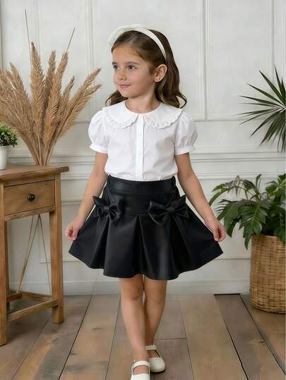 SHEIN Girls' Elegant Black Skirt With Pleated Design And Elastic Waistband, Featuring A Bow Detail On The Front. Suitable For Everyday Wear, Parties, And Formal Occasions. Pairs Perfectly With Tops And Coats For A Sophisticated And Outstanding Look.