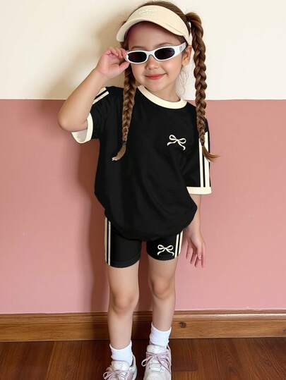 SHEIN Black Contrast Stripe, Mini Bow Print, Young Girl Casual Minimalist Comfortable Round Neck Loose Short Sleeve T-Shirt Top And Skinny Bike Shorts Leggings Set, Suitable For Daily Wear, Street Style, Outings, Home, Vacation, Sports, Homecoming, Back To School, Spring & Summer