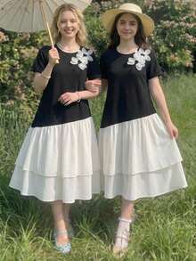 这款少女连衣裙采用经典的黑白撞色设计，宽松的A字上衣为纯黑色，层叠荷叶边裙摆为米白色，视觉对比鲜明却又和谐统一，宽松的版型适合各种身材，甜美俏皮的风格，是春夏穿着的理想之选。 - 彩色 - 查看 6