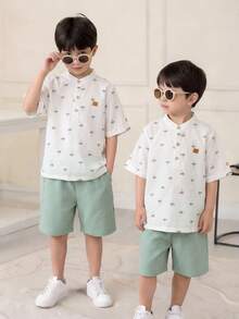 SHEIN 2pcs/Set Young Boy Cartoon Coconut Tree Pattern Mandarin Collar Short Sleeve Half-Zip Pullover Top And Elastic Waist Solid Color Shorts,Kids - White - View 8