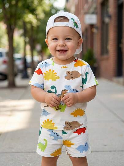 SHEIN Toddler Boys' Dinosaur Cartoon Print Round Neck Short Sleeve T-Shirt And Matching Elastic Waist Shorts Set, Children's Clothing, Infant & Toddler Set, Infant & Toddler Short Sleeve Shorts Set, Baby Boy Set, Baby Boy T-Shirt Set, Dinosaur Element. Suitable For Spring/Summer, Summer, Fits 6M-3T