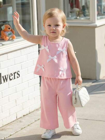 Souflis Souflis 2件套 新生儿-3岁女童时尚可爱3D蝴蝶结装饰无袖上衣和七分裤套装，适合日常穿着和度假，春夏皆宜