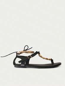 Nöista Embellished Black Thong Sandals. A Sleek Black Sandal Design Featuring A Central T-Strap Adorned With Intricate Gold Geometric Beads-The Perfect Blend Of Bohemian Flair And Refined Elegance. - Black - View 5