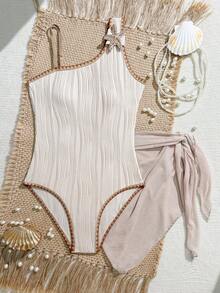 SHEIN Bộ áo tắm liền thân và váy sarong màu hồng đào nhạt dành cho thiếu nữ, họa tiết vỏ sò lượn sóng, mang đến phong cách biển cả dịu dàng. - Màu be - Xem 1