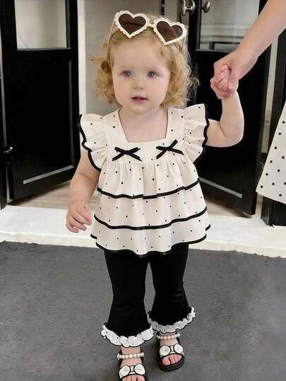 Souflis Souflis 女婴夏季黑白波点装饰层叠荷叶边上衣和喇叭裤套装，适合日常外出、休闲聚会、家庭派对和与朋友外出。