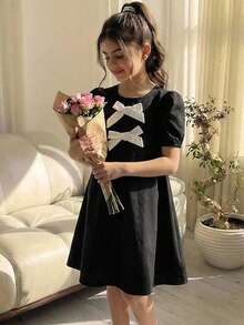 女童休闲度假绿色蝴蝶结花瓣袖圆领连衣裙，甜美公主风，柔软舒适，适合夏季郊游、旅行、校园及日常穿着。 - 黑色 - 查看 7