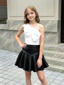 Elladie kids Conjunto de 2 piezas dulce y fresco para niñas preadolescentes, top de un hombro con lazo a juego con minifalda de cuero PU con tachuelas, ajustado y favorecedor, que irradia un ambiente dulce y caliente de chica, adecuado para salidas casuales, fiestas o uso escolar, fácil de crear looks personalizados - Blanco y Negro - Ver 9