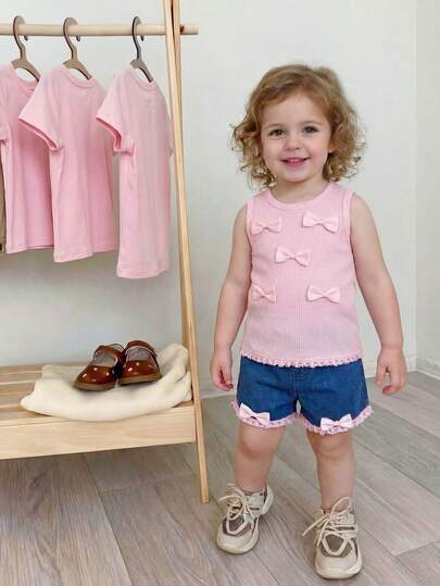 SHEIN Playful Pals 2pcs Girls' Outfit Set, Sleeveless Round Neck Top + Denim Shorts, Made Of Pink Knit Fabric, Decorated With Pink Bow On Chest And Pink Lace Trim On Hem, Waist With Elastic Design, Lace And Bow Trim On Shorts Hem, Sweet And Playful Style, Suitable For Daily Outings, Entertainment And Play