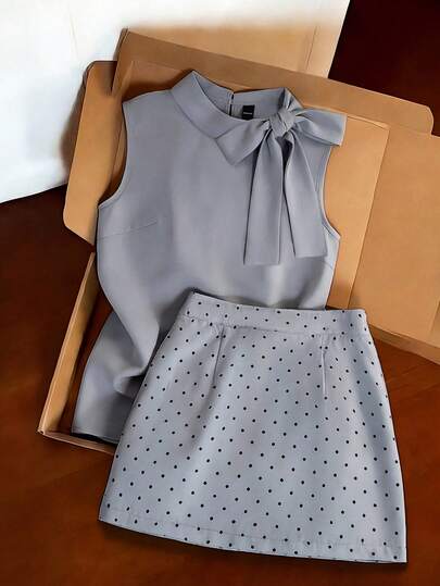 Franclia Light Gray Work Suit Featuring A Sleeveless Turtleneck Top Paired With A Polka-Dot Mini Skirt. The Simple, Fitted Design Accentuates The Waistline. The Fabric Is Smooth And Soft, And The Bow On The Top And The Evenly Spaced Polka Dots On The Skirt Showcase Meticulous Craftsmanship. The Style Is Simple And Elegant, Perfect For A Female Teacher's Outfit With A Rustic, Vacation Vibe. Suitable For Winter, Summer, Spring, Valentine's Day, Romantic Dates, Beaches, Weddings, Birthdays, Outings, Elegant Casual Wear, Vacations, Graduation Season, And More. (Summer, Women's Summer Suit, Summer Holiday Outfit, Summer Clothing, Women's Spring Outfit, Spring Break Outfit, Beach Suit, Women's Elegant Outfit, Women's Elegant Suit, Women's Casual Suit, Back-To-School Suit)Graduation Season Attire, Fashionable Casual Commuter Wear, Business Office Wear, Versatile And Stylish Everyday Casual Wear, Urban Teacher's Professional Attire