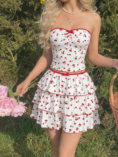SHEIN MOD White Polyester Fabric Two-Piece Set, Red Cherry Print, Strapless Ruched Bustier Top, Sweetheart Neckline, Red Lace Trim, Small Bow Detail, High-Waisted Tiered Mini Skirt, Ruffle Layers, Red Piping Edges, Lightweight Material, Smooth Texture, Breathable Fabric, Playful Design, Feminine Silhouette, Fitted Top, Flared Skirt, Vibrant Color Contrast, Comfortable Wear, Youthful Style, Casual Look, Delicate Stitching, Eye-Catching Pattern.