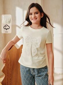 Anewsta Camiseta de manga corta con cuello redondo y decoración de lazo, en color amarillo suave, 100% algodón, para niña - Amarillo - Ver 2