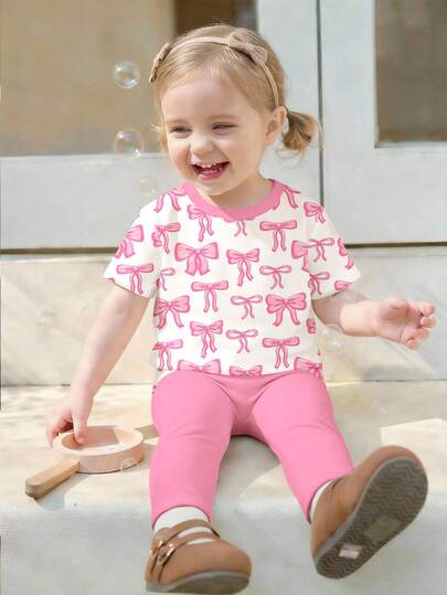 SHEIN Cream White & Cream Pink, Cute Bow Print, Baby Girl Casual Minimalist Soft Round Neck Loose Short Sleeve T-Shirt And Leggings Set, Suitable For Daily Wear, Street Style, Outings, Home, Vacation, Homecoming, Back To School, Spring & Summer Girls Outfits