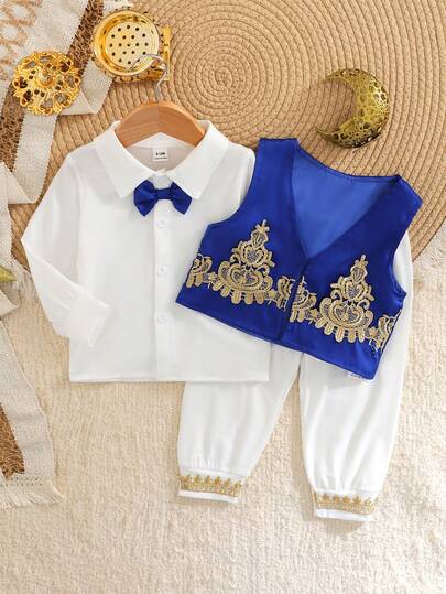 Conjunto de 3 piezas para bebé niño con camisa de estilo medio oriental con corbata de moño de color contrastante + chaleco azul marino + pantalones de punto con decoración de dobladillo floral para primavera