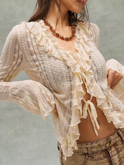 Bohemela Damtopp med långärmad, volang och V-ringning, i enfärgad och avslappnad passform.