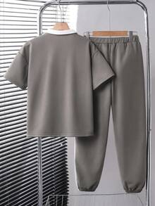 طقم بولو كاجوال للأولاد، قطعتان، ملابس علوية بتصميم ألوان متباينة والنسيج المنسوج، وبنطلون بتصميم ألوان متداخلة وساق ضيقة، من قماش مريح، مناسب للصيف والخريف - لون مشمشي - مشاهدة 2