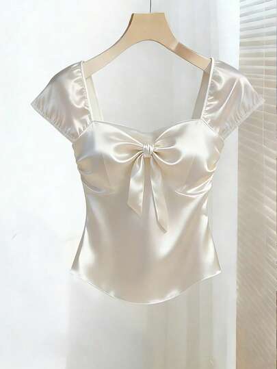Franclia Women's Top, Women's Sleeveless Backless Top, Short, White, Solid Color, Pure Desire Top, Perfect For Valentine's Day Dates And Romantic Outfits. Features A Bow Design On The Chest, Exuding A Romantic Atmosphere. Made Of Tulle Satin Material, It Showcases Elegance And Noble Charm. A New Fashion And Stylish Evening Top, Perfect For Formal Events, Guest Attire, And Party Birthday Outfits. Satin Top Bow Top Satin Blouses For Women Women Tops Elegant Silk Top