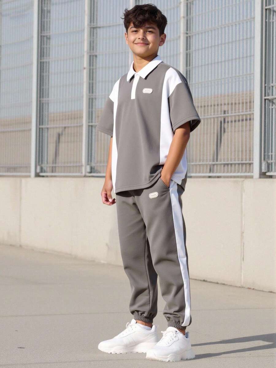 طقم بولو كاجوال للأولاد، قطعتان، ملابس علوية بتصميم ألوان متباينة والنسيج المنسوج، وبنطلون بتصميم ألوان متداخلة وساق ضيقة، من قماش مريح، مناسب للصيف والخريف - لون مشمشي - مشاهدة 1