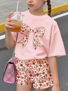 Bộ 2 món cho bé gái tuổi teen, gồm áo thun ngắn tay cổ tròn thắt nơ và quần short họa tiết hoa nhí, thích hợp mặc hàng ngày vào mùa hè, đi chơi, nghỉ mát, du lịch, thư giãn mùa hè. - Nhiều màu - Xem 1