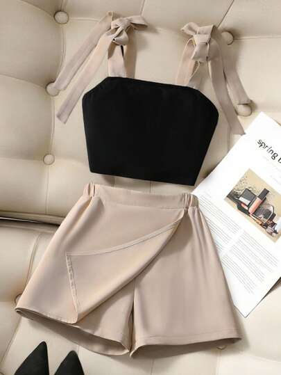 SHEIN Bộ áo hai dây và quần short có nơ rời cho bé gái, bộ 2 món mùa hè mới gợi cảm gồm áo hai dây ngắn xếp ly nơ phối màu tương phản + quần short kaki, váy quần short buộc dây cho bé gái, bộ 2 món mùa xuân/hè cho bé gái, trang phục thường ngày mùa hè cho trẻ em, bộ 2 món phối màu mùa xuân/hè cho bé gái, quần áo mùa hè cho bé gái, thích hợp cho kỳ nghỉ, hẹn hò.