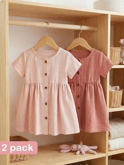 SHEIN 两件套女婴纯棉休闲纯色纽扣圆领短袖连衣裙套装，粉色和杏色，适合1-3岁宝宝。纽扣前襟设计方便穿脱，适合日常穿着或户外活动。性价比高，春夏新品。