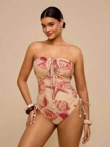 Travachic Áo tắm liền thân hở lưng, cổ yếm, họa tiết vỏ sò màu cam hồng, kiểu dáng gợi cảm, thích hợp cho kỳ nghỉ nhiệt đới, cổ chữ V sâu và có dây rút ở eo, giúp thon gọn vóc dáng, phong cách quyến rũ bãi biển, mùa hè. - Hồng - Xem 1