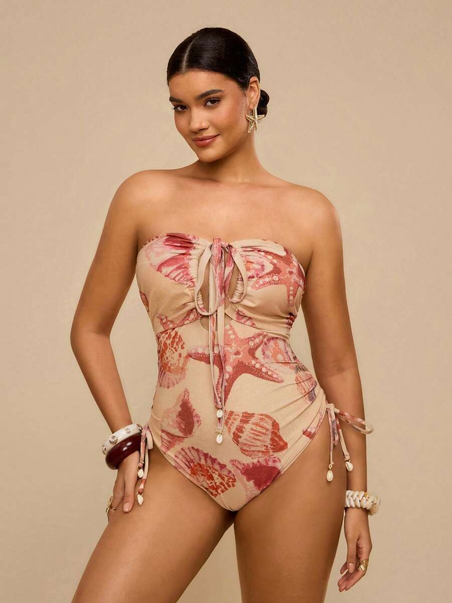 Travachic Áo tắm liền thân hở lưng, cổ yếm, họa tiết vỏ sò màu cam hồng, kiểu dáng gợi cảm, thích hợp cho kỳ nghỉ nhiệt đới, cổ chữ V sâu và có dây rút ở eo, giúp thon gọn vóc dáng, phong cách quyến rũ bãi biển, mùa hè. - Hồng - Xem 1