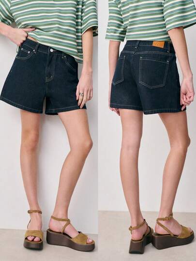 Nöista Quần short denim cạp cao màu xanh hải quân có kiểu dáng chữ A, đường cắt thẳng thoải mái và thiết kế năm túi cổ điển giúp kéo dài đôi chân. Đa năng và vượt thời gian, chúng hoàn hảo để mặc thường xuyên trong mùa hè.