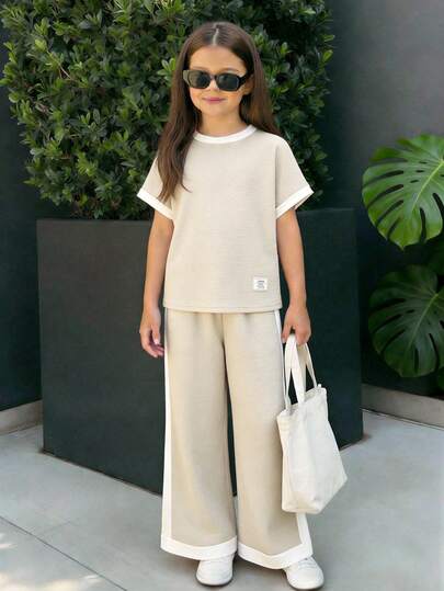 مجموعة بنطلون وتي شيرت للبنات المراهقات، تي شيرت بياقة دائرية وأكمام راجلان بتصميم أبيض وأسود متباين، بنطلون مستقيم من القماش المحبوك