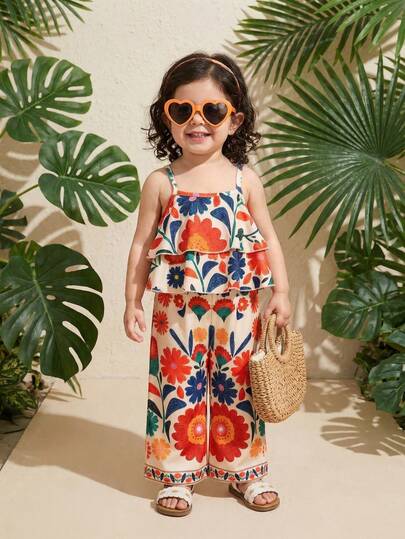 SHEIN Playful Pals 两件套女童碎花宽松吊带背心+裤子，度假风休闲夏季套装。色彩缤纷的碎花吊带背心套装充满夏日气息，采用舒适亲肤的面料。吊带背心搭配阔腿裤，尽显童趣可爱，适合女孩日常穿着、户外活动或夏季家庭聚会。
